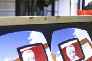 Computer screen with VR application, person in the background